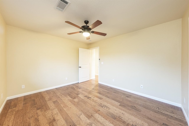 spare room with visible vents, baseboards, light wood-style floors, and a ceiling fan