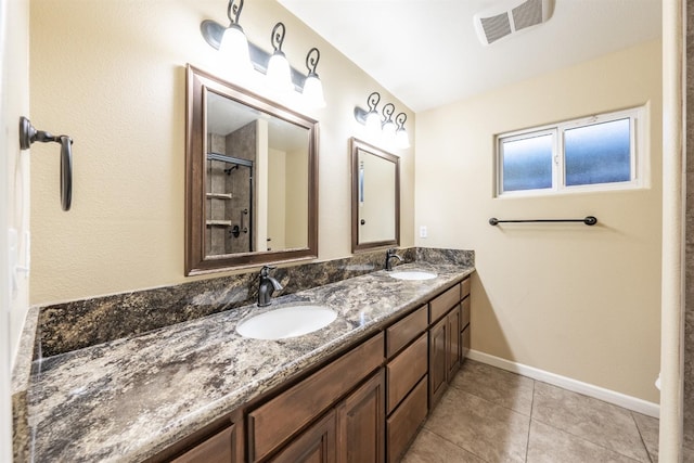 full bathroom featuring double vanity, a shower with shower door, visible vents, and a sink