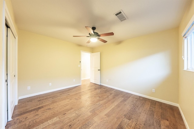 unfurnished bedroom featuring visible vents, ceiling fan, baseboards, light wood-style floors, and a closet