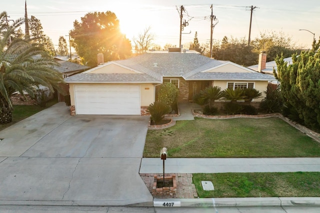 ranch-style home featuring a garage, driveway, a front lawn, and stucco siding