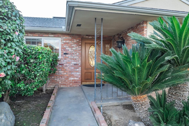 property entrance with brick siding