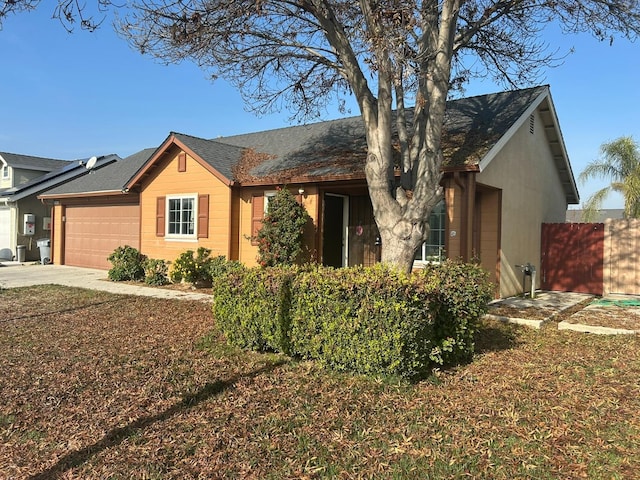 single story home featuring an attached garage, fence, and driveway