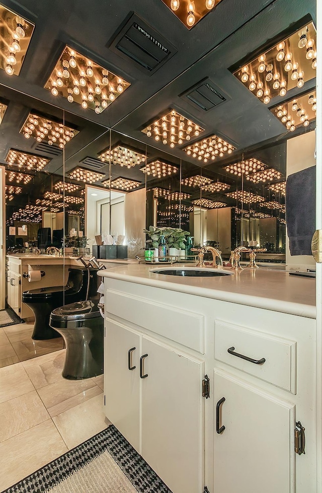 bar with indoor wet bar, visible vents, and a sink