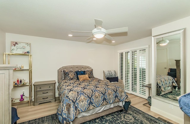 bedroom featuring a ceiling fan, access to exterior, and wood finished floors