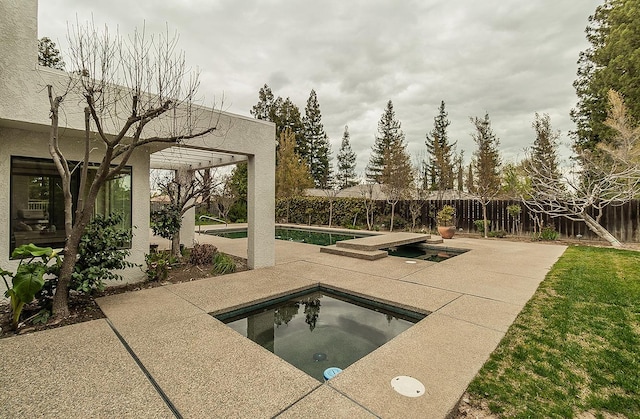 view of pool with a fenced backyard, a fenced in pool, an in ground hot tub, and a patio