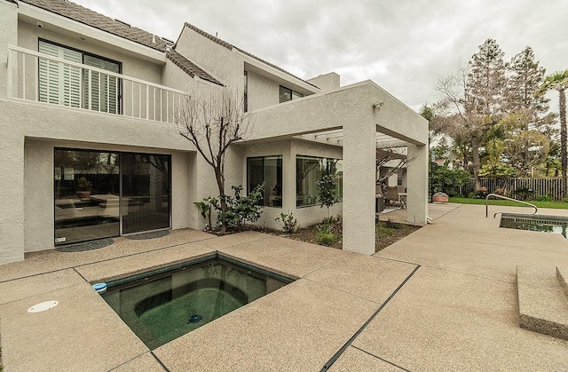 view of swimming pool with a patio, an in ground hot tub, and fence