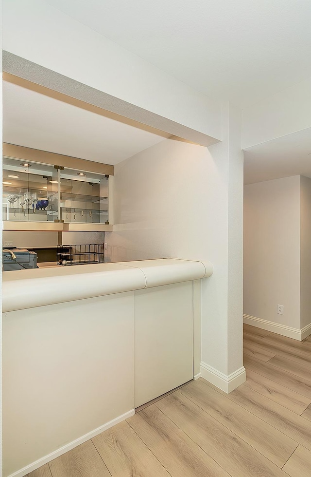 bar with light wood-type flooring and baseboards