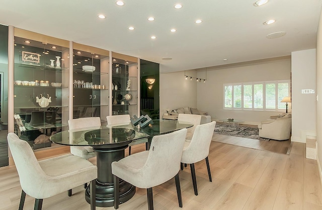 dining area featuring recessed lighting, baseboards, and wood finished floors