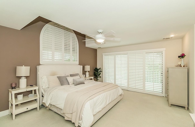 bedroom featuring visible vents, light carpet, baseboards, and a ceiling fan