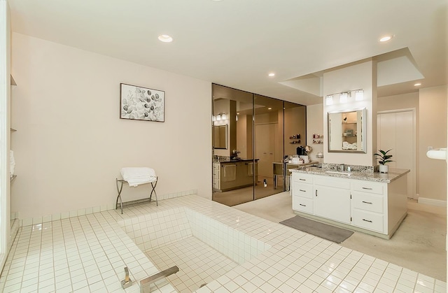 full bath with a sink, two vanities, recessed lighting, and tile patterned floors