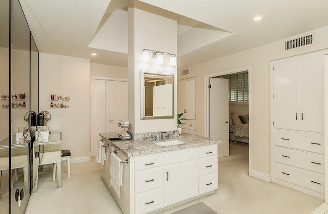 bathroom featuring visible vents, recessed lighting, and vanity