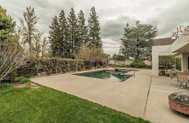 view of swimming pool with a patio, a fenced backyard, a fenced in pool, and a lawn