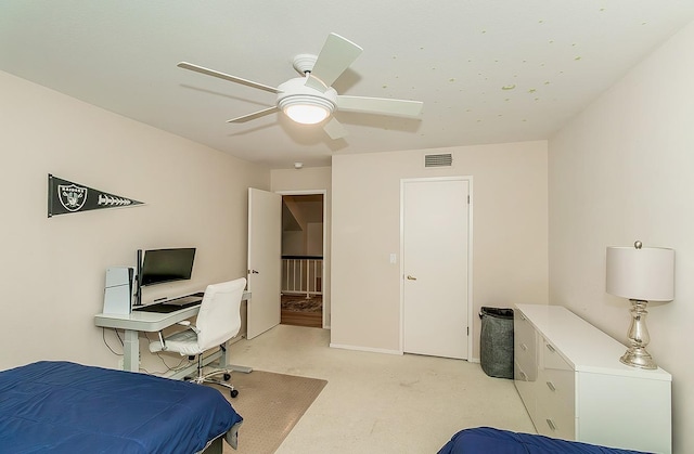 bedroom with visible vents, baseboards, light colored carpet, and a ceiling fan