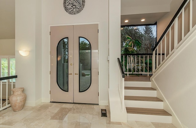 foyer with visible vents, baseboards, stairway, recessed lighting, and french doors