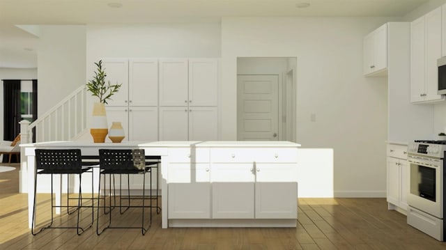 kitchen with white cabinetry, light wood-type flooring, white range with gas stovetop, and baseboards