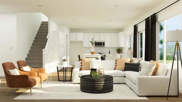 living area featuring stairs and light wood finished floors