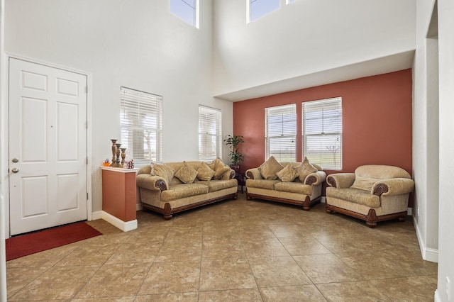 living area featuring light tile patterned floors, plenty of natural light, and baseboards