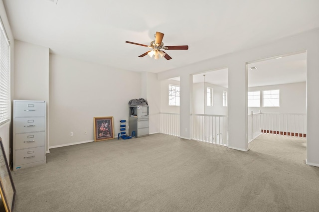 carpeted spare room featuring ceiling fan