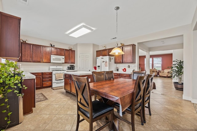 dining area featuring light tile patterned flooring