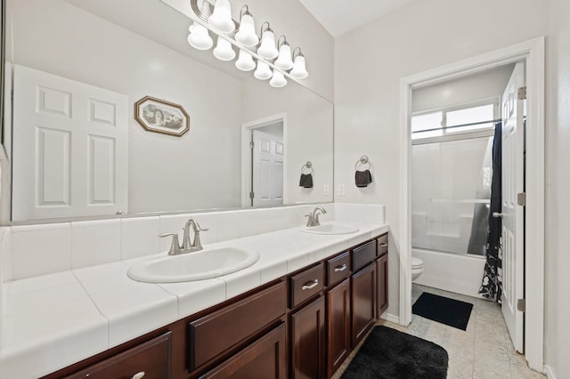 full bathroom with double vanity, toilet, shower / bathtub combination, and a sink