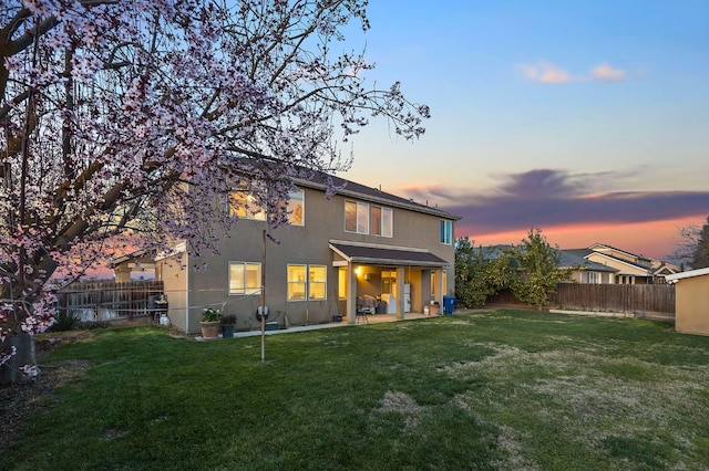 1410 Azalea St, Kingsburg, CA 93631 - back of property with a fenced backyard, a patio, and stucco siding
