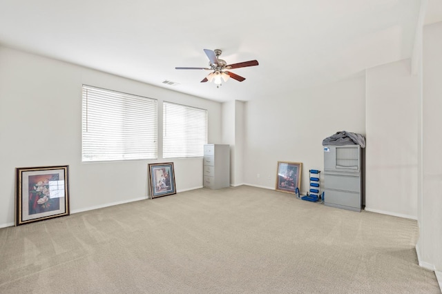 interior space with visible vents, baseboards, and ceiling fan