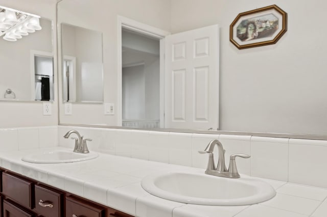 full bath with double vanity, backsplash, and a sink