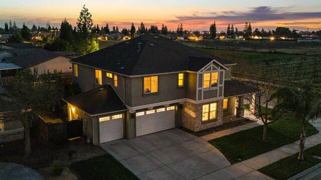 1410 Azalea St, Kingsburg, CA 93631 - view of front of property with a garage, concrete driveway, stucco siding, and stone siding