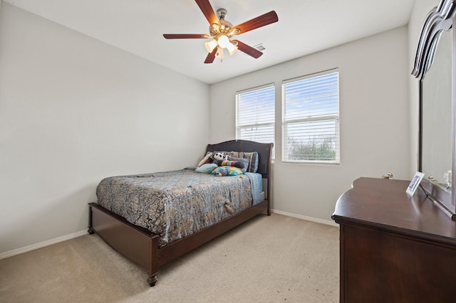 bedroom with light carpet, visible vents, ceiling fan, and baseboards