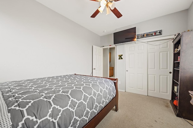 carpeted bedroom featuring a closet and a ceiling fan