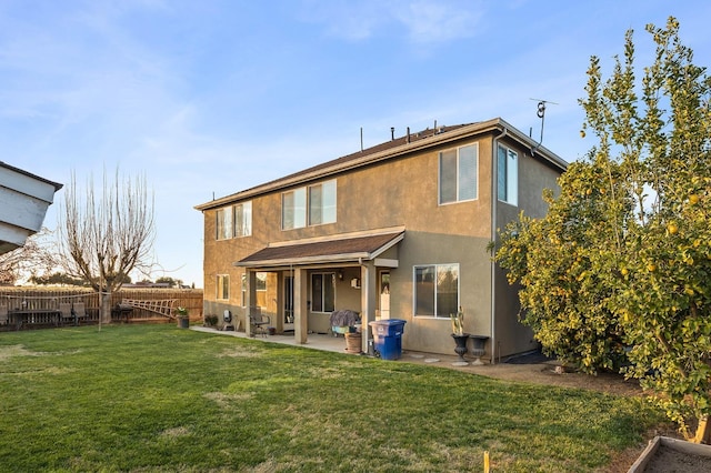 1410 Azalea St, Kingsburg, CA 93631 - back of property with a fenced backyard, a patio area, and stucco siding