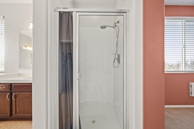 bathroom featuring a stall shower and vanity