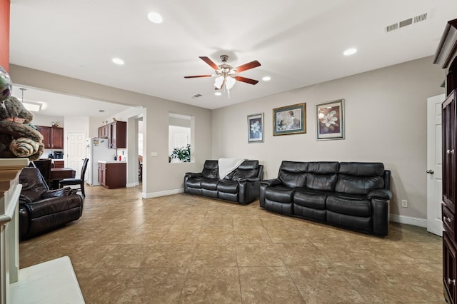 living room with visible vents, recessed lighting, a ceiling fan, and baseboards