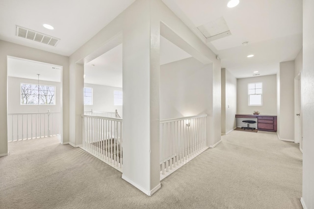 hall featuring recessed lighting, visible vents, carpet flooring, and baseboards