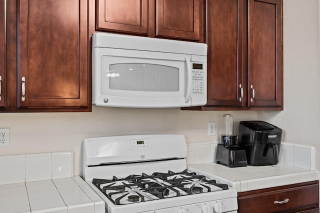 kitchen with white appliances and tile counters