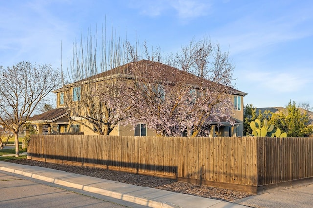 view of home's exterior featuring a fenced front yard and stucco siding