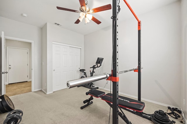 workout area with visible vents, carpet flooring, baseboards, and ceiling fan