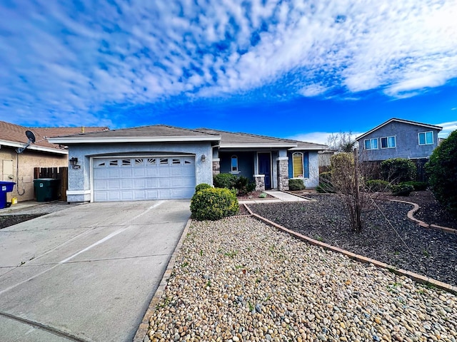 ranch-style house with a garage, driveway, and stucco siding