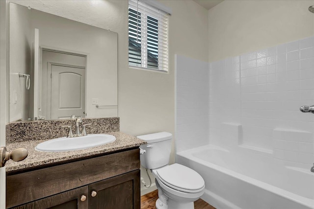 full bath with vanity, toilet, wood finished floors, and bathtub / shower combination