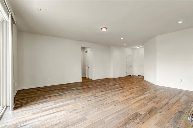 spare room featuring recessed lighting and light wood-style floors