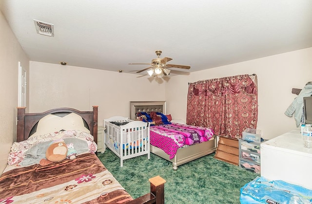 carpeted bedroom featuring visible vents and ceiling fan