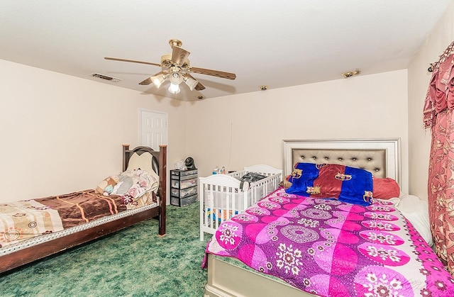 bedroom with carpet flooring, a ceiling fan, and visible vents