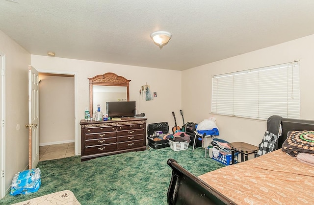 carpeted bedroom with tile patterned floors and a textured ceiling