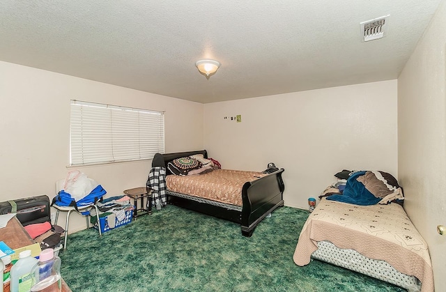 carpeted bedroom with visible vents and a textured ceiling