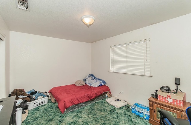 carpeted bedroom with a textured ceiling