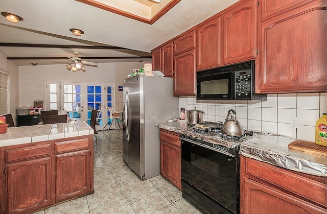 kitchen with light tile patterned floors, ceiling fan, black appliances, french doors, and tasteful backsplash