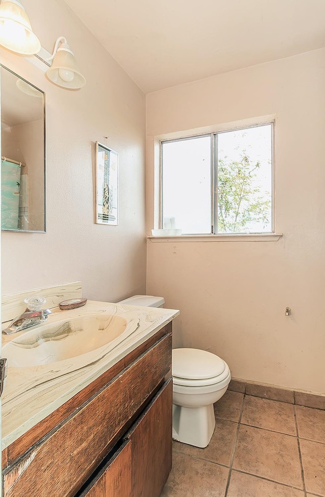 bathroom with tile patterned floors, curtained shower, toilet, and vanity