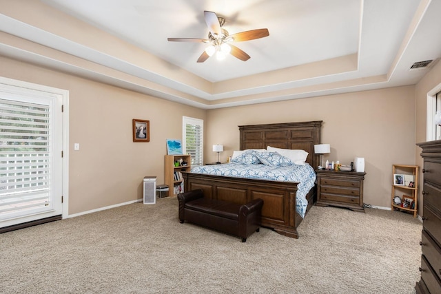 bedroom featuring visible vents, a raised ceiling, and baseboards