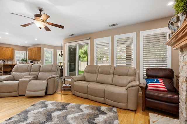 living room featuring recessed lighting, light wood-type flooring, visible vents, and a ceiling fan