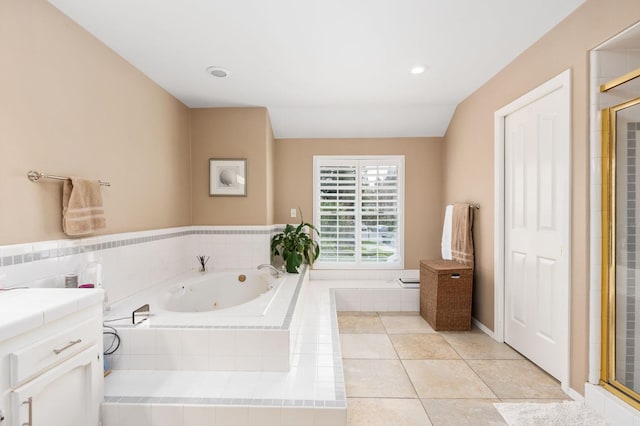 full bathroom featuring tile patterned flooring, a shower stall, a jetted tub, and vanity